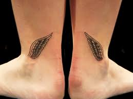 women tattoo designs feather on leg