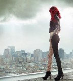 red hair girl tattoo looking at the city