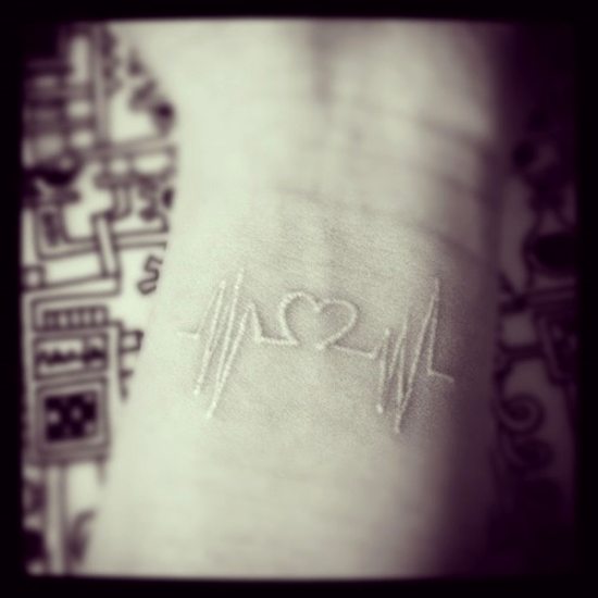 white ink tattoo heartbeat