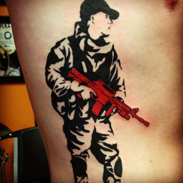 banksy graffiti tattoo soldier with red gun