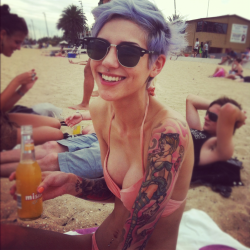 beach girl tattoo girl with piercing blue hair