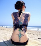 beach girl tattoo peacock feathers