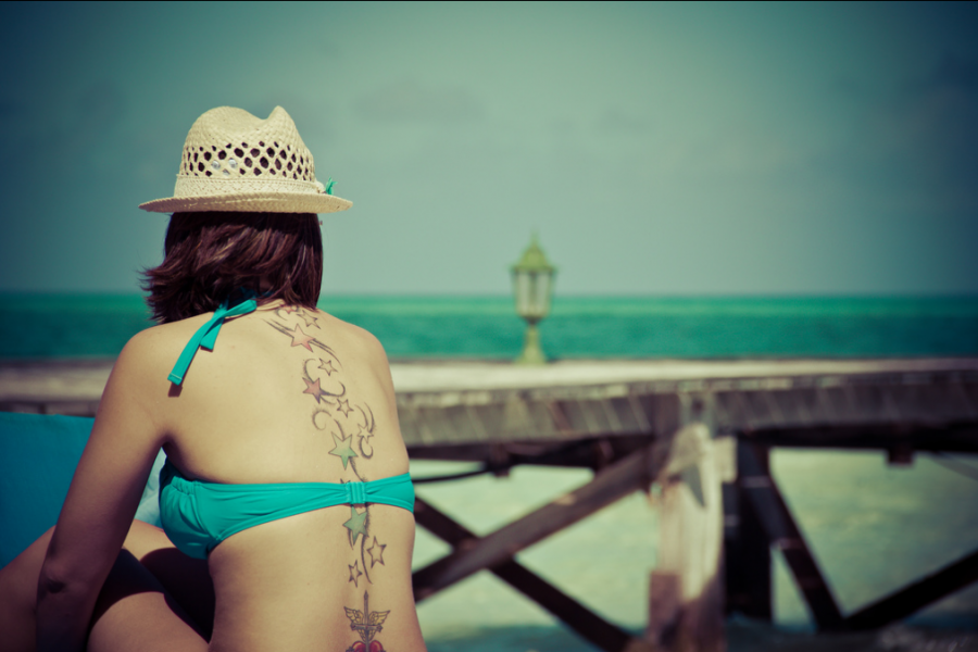 beach girl tattoo stars spine tattoo