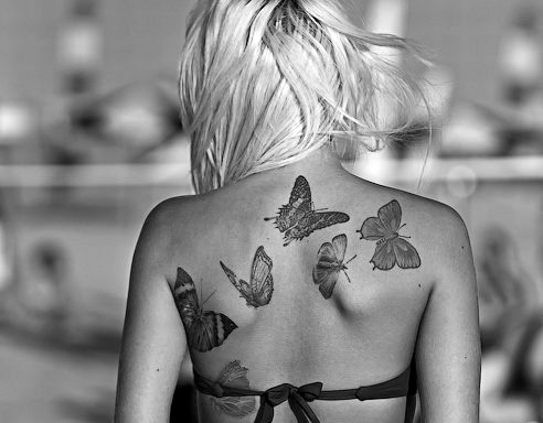 black and white photo buttreflies back tattoo