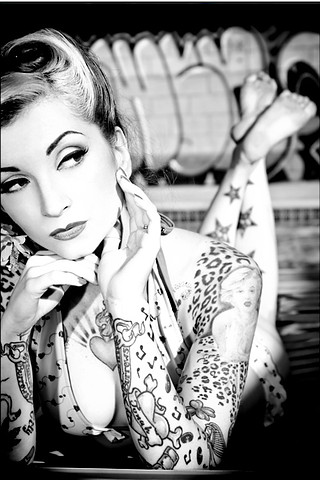 black and white photo full sleeves tattoo stars on back legs