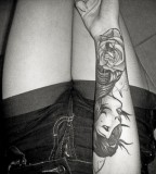 black and white photo girl and rose arm tattoo