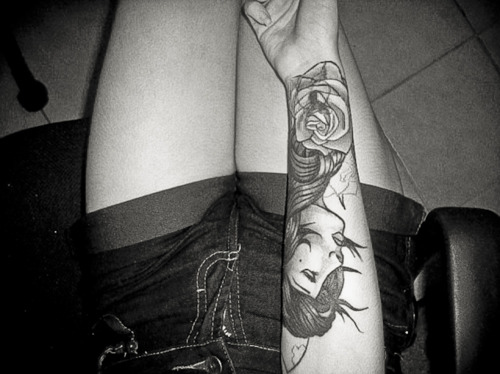 black and white photo girl and rose arm tattoo
