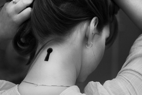 black and white photo key hole back neck tattoo