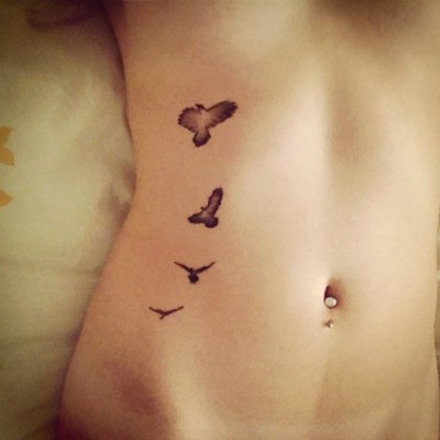 elegant bird tattoo belly