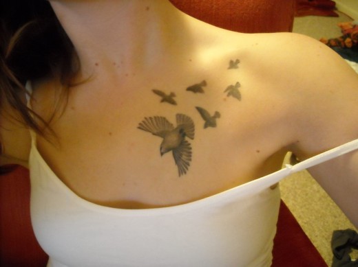elegant bird tattoo chest tattoo design
