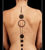 geometric abstract tattoo black circles spine tattoo