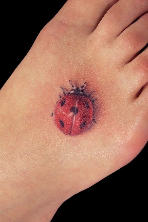 realistic tattoo lady bug on foot