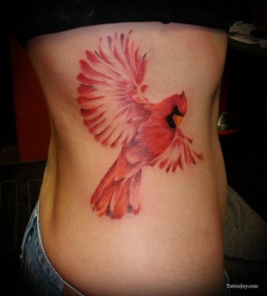 red ink tattoo bird on ribs