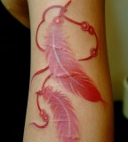 red ink tattoo feathers
