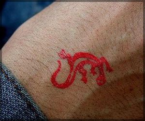 red ink tattoo small lizard