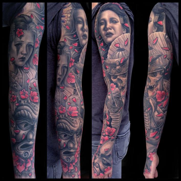 tattoo by Mike DeVries faces red blossoms sleeve
