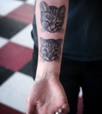 cat head on inside arm tattoo