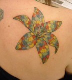 colorful puzzle flower tattoo