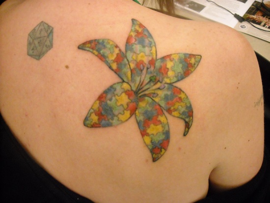 colorful puzzle flower tattoo