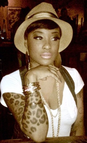 leopard print tattoo on dark skinned girl with hat