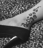 leopard print tattoo on leg black high heel