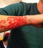 red ink wrist tattoo