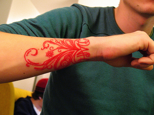 red ink wrist tattoo