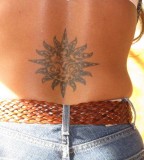 sun tattoo on the lower back