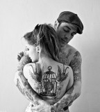tattooed couple hugging