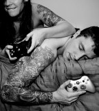 tattooed couple playing video games