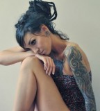 tattooed girl with dreadlocks blue dreads and tattoo