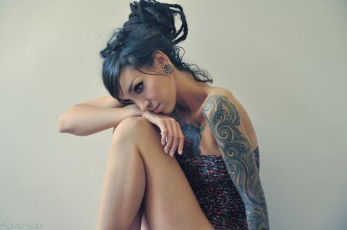tattooed girl with dreadlocks blue dreads and tattoo