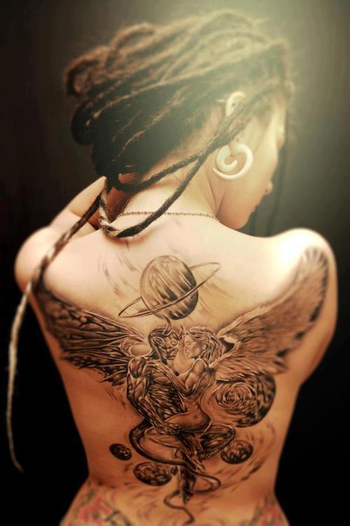 tattooed girl with dreadlocks devil and angel back tattoo