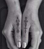 arrow tattoos on thumbs by jean philippe burton