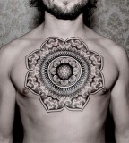 big mandala tattoo on chest