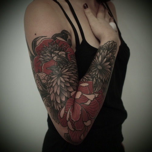 black and red flower arm sleeve tattoo by guy le tattooer
