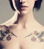 feminine colibri chest tattoo