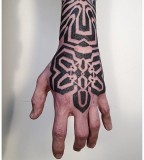 hand and arm blackwork tattoo by victor j webster