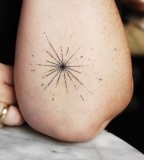 tiny aurora tattoo on arm