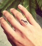 tiny giraffe finger tattoo