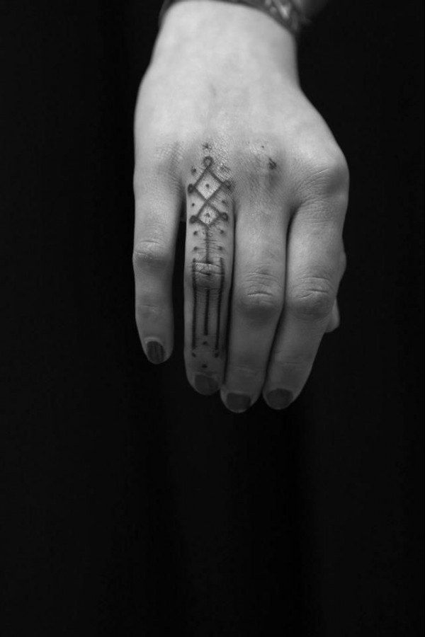 tiny pattern finger tattoo