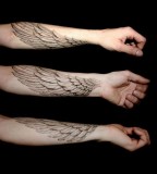 Arm wings tattoo