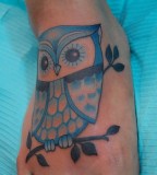 Blue owl tattoo on foot