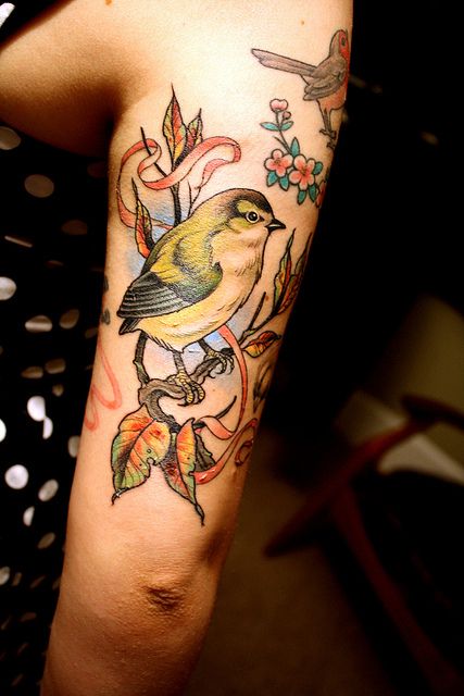 Colorful flying bird tattoo