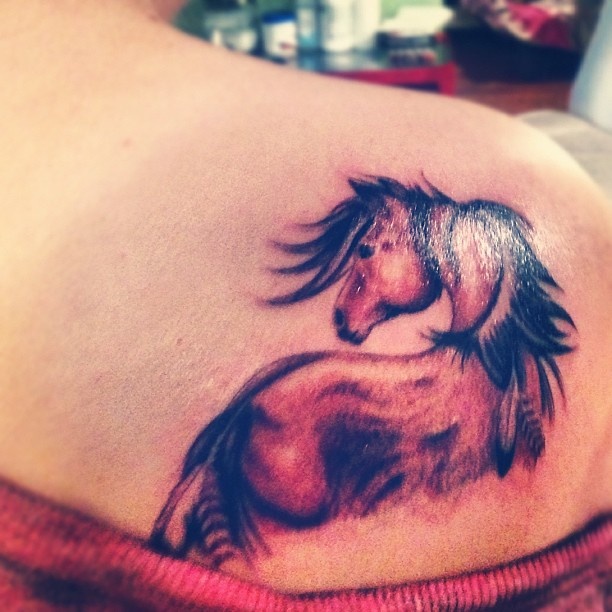Colorful horse tattoo on shoulder