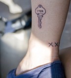 Cute key tattoo on leg