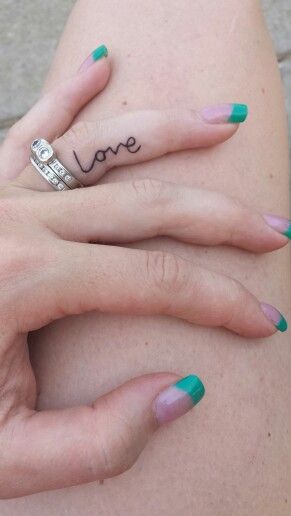 Love tattoo on ring finger