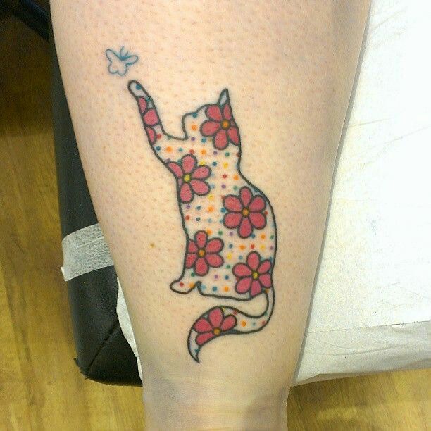 Red flowers and cat tattoo