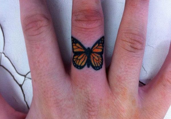Simple butterfly tattoo on finger