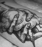 alex tabuns hand holding cloud tattoo
